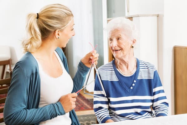 Caregiver engaging with elderly resident in a friendly conversation