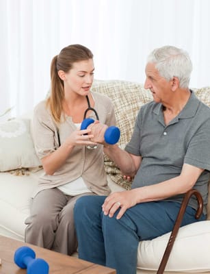 Therapist helping a senior man with exercise.