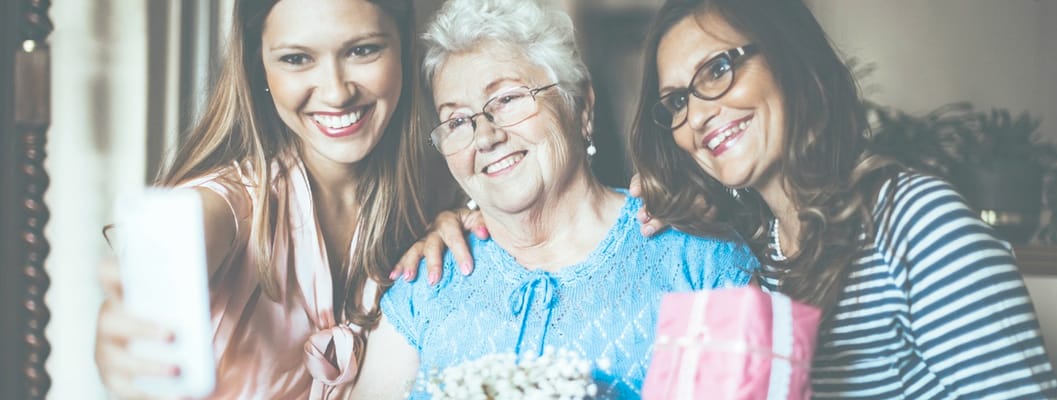Residents and staff celebrating with a gift