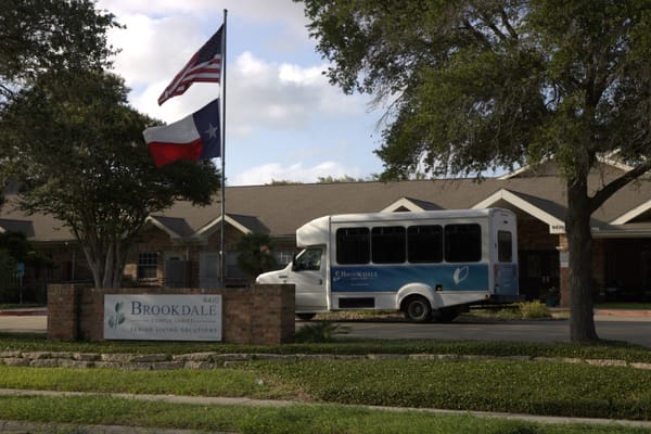 Facility exterior with building and bus in view