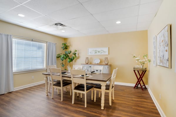 Interior dining room setup with wooden table and chairs