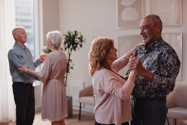 Residents dancing in a bright common area