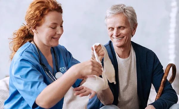 Healthcare staff assisting a senior resident