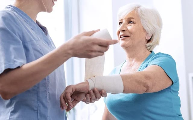Nurse assisting a resident with arm care