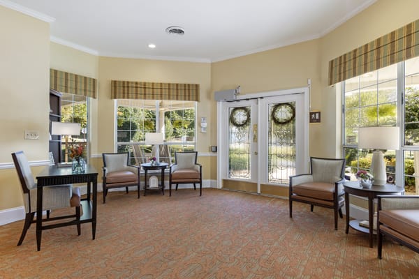 Bright common area with seating and entrance doors