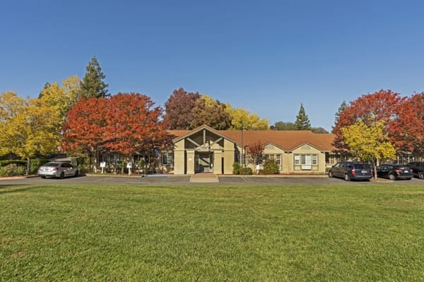 Front view of Brookdale Roseville facility surrounded by autumn trees