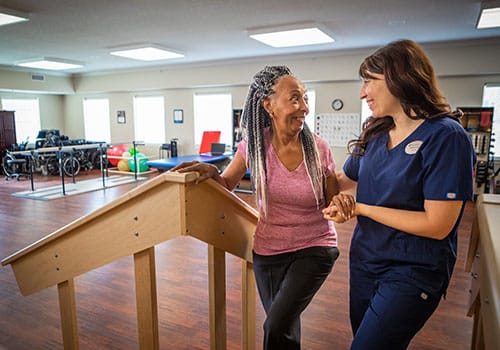 Staff member assisting a resident in an activity room