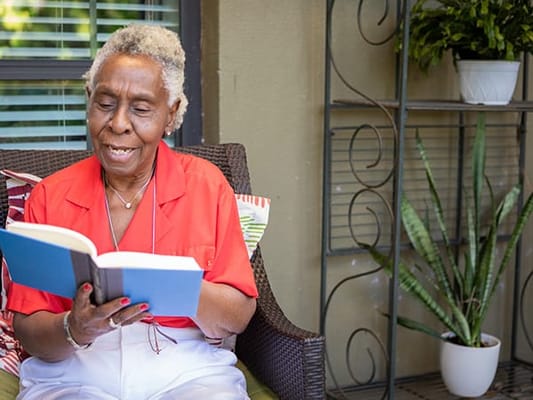 Resident reading a book in a common area
