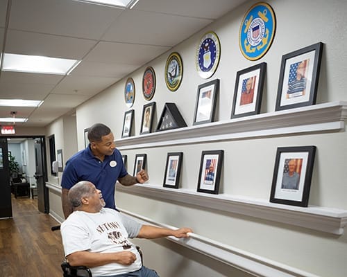 Staff engaging with a resident in a hallway