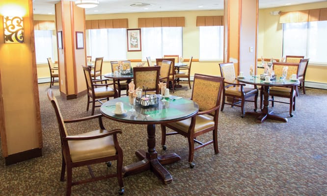 Dining area with tables and chairs set up for residents