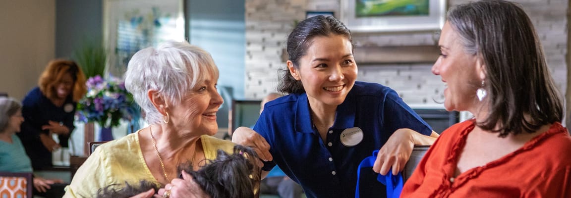 Staff interacting with residents in an activity room