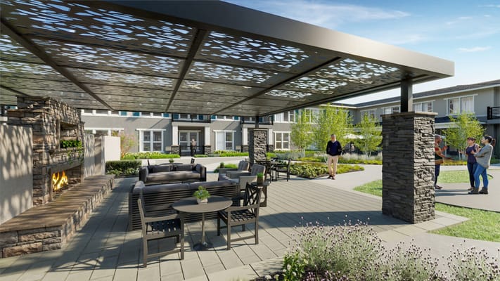 Cozy outdoor lounge with seating and a fireplace