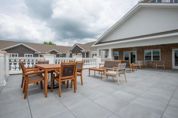 Outdoor patio area with wooden tables and chairs