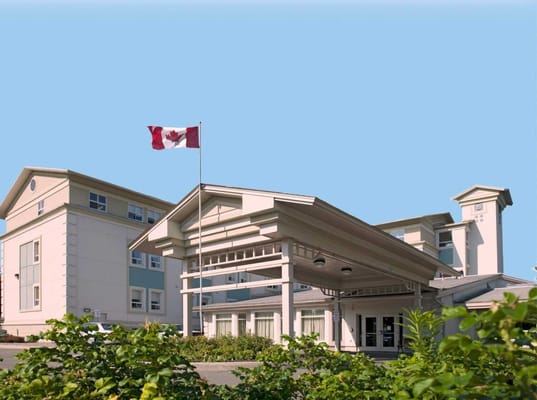 Exterior view of Billingswood Manor with Canadian flag
