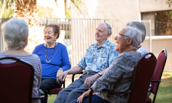 Seniors enjoying a social gathering in an outdoor setting