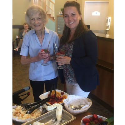 Resident and staff enjoying fruit desserts together