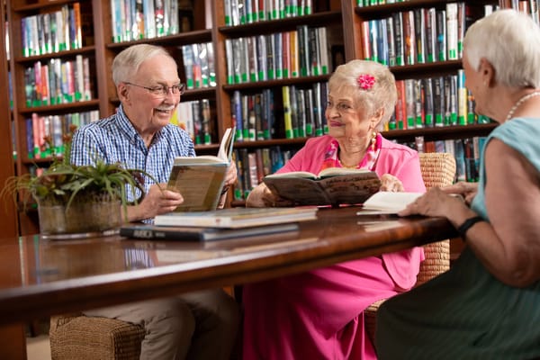 Residents enjoying books in a library
