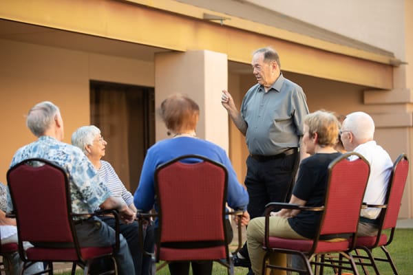 Residents engaged in a discussion outdoors