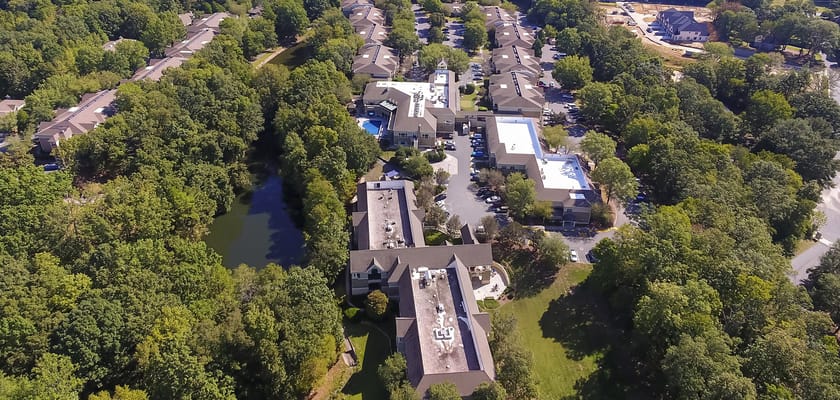 Aerial view of a senior living facility surrounded by greenery