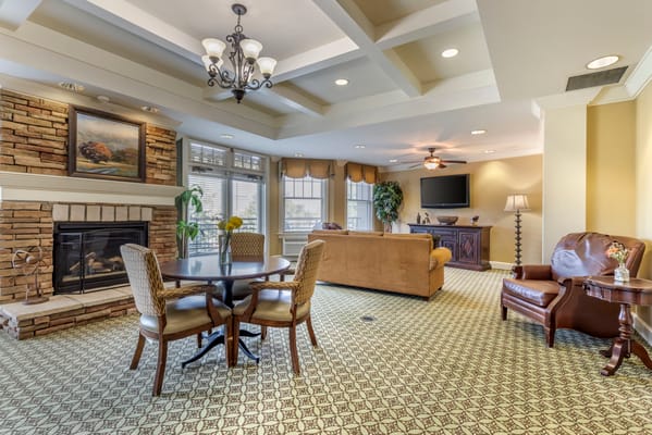 Bright common area with seating and a fireplace