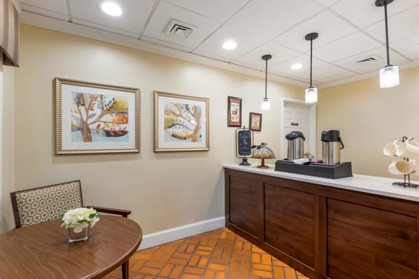 A cozy common area with coffee service and decor