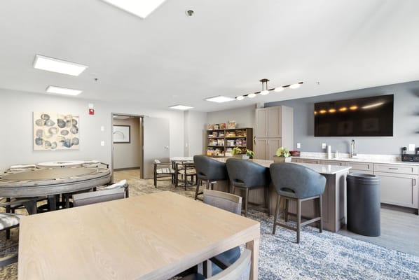 Common area with dining tables and kitchenette