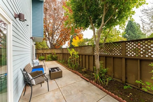 Outdoor patio with seating and greenery