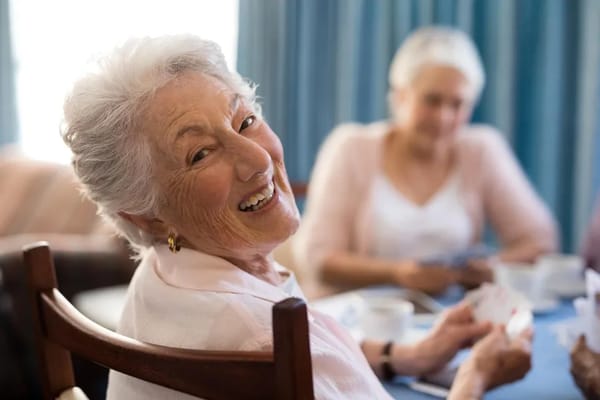 Smiling elderly woman enjoying a social moment