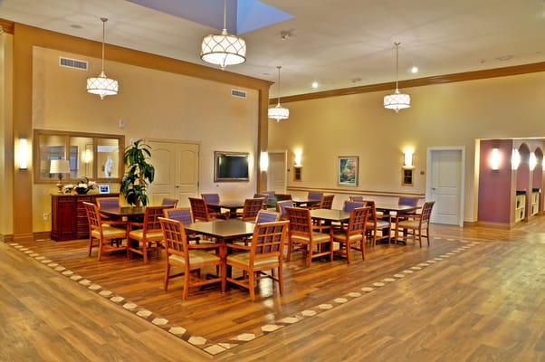 Bright common area with dining tables and chairs