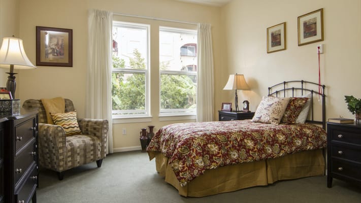 Cozy resident room with a bed and chair