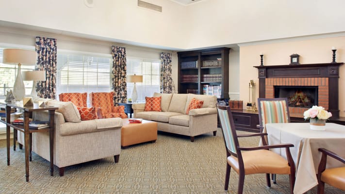 Bright common area with comfortable seating and a fireplace