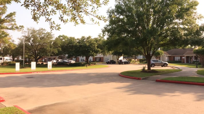 Outdoor view of the facility with trees and parking
