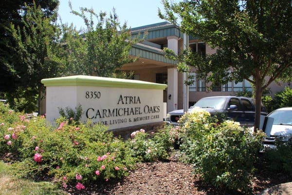Exterior sign of Atria Carmichael Oaks with landscaping