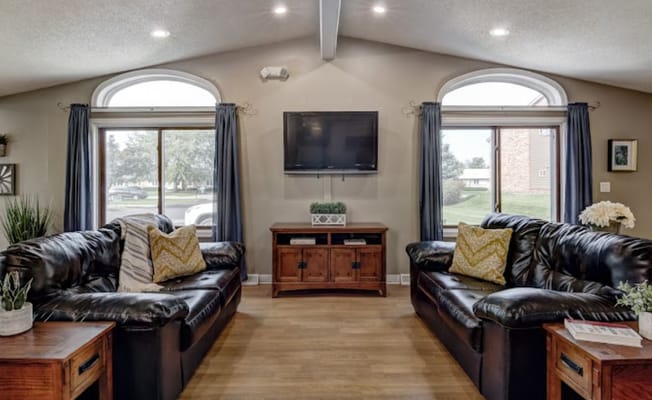 Bright common area with comfortable seating and windows