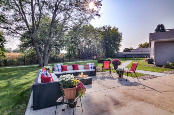 Outdoor seating area with flowers and cushions
