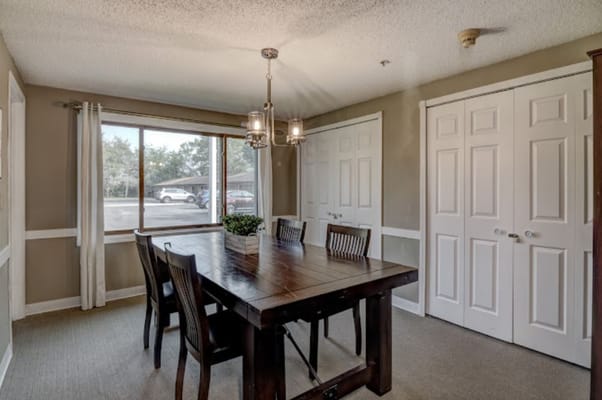 Dining area with a large wooden table and chairs