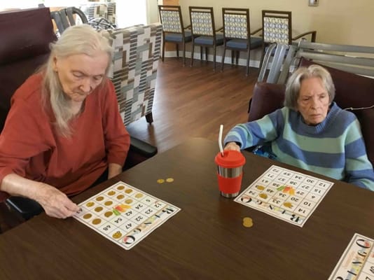 Residents playing bingo at a communal table