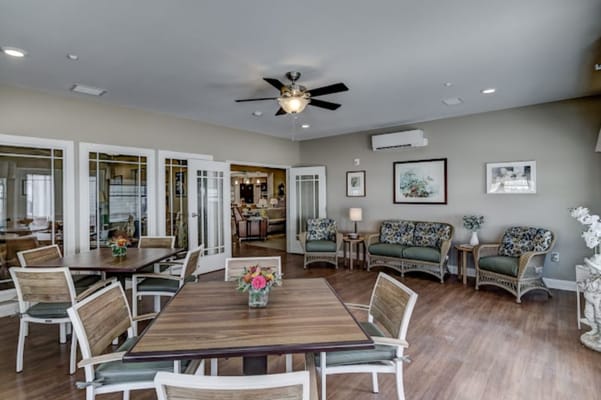 A welcoming common area with seating and tables in Azura Memory Care.