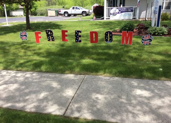 Decorative 'FREEDOM' sign on the lawn