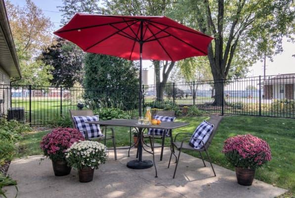 Outdoor seating area with flowers and an umbrella