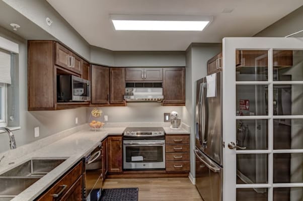 Modern kitchen with wooden cabinets and stainless steel appliances