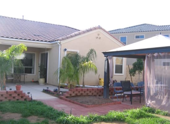 Outdoor patio area with seating and landscaping