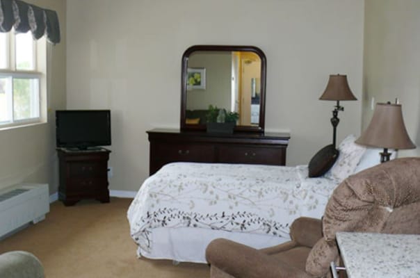 Cozy resident room with a bed and furniture