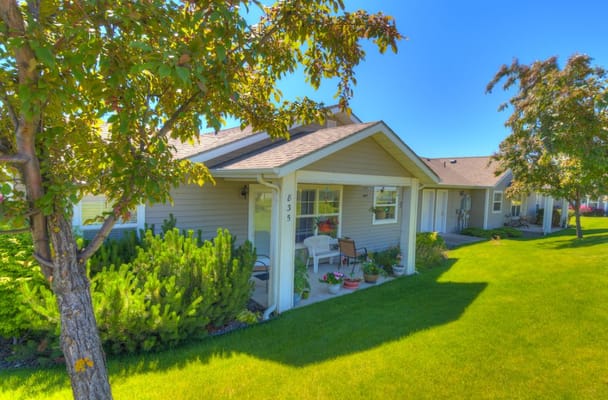 Exterior view of senior living units with greenery