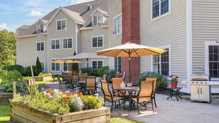 Outdoor patio area with seating and gardens