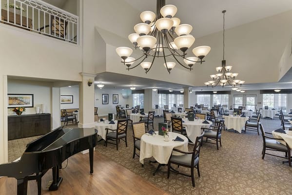 Bright dining room with tables set for meals