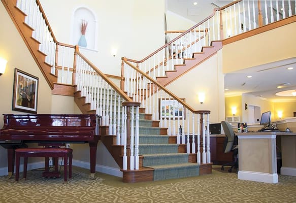 Interior view of a lobby with staircase and piano