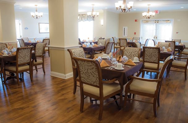 Bright dining room with tables set for meals