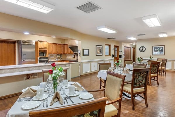 Dining room setup with tables and flowers