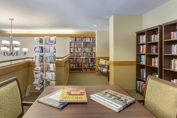 Cozy library space with bookshelves and a reading table